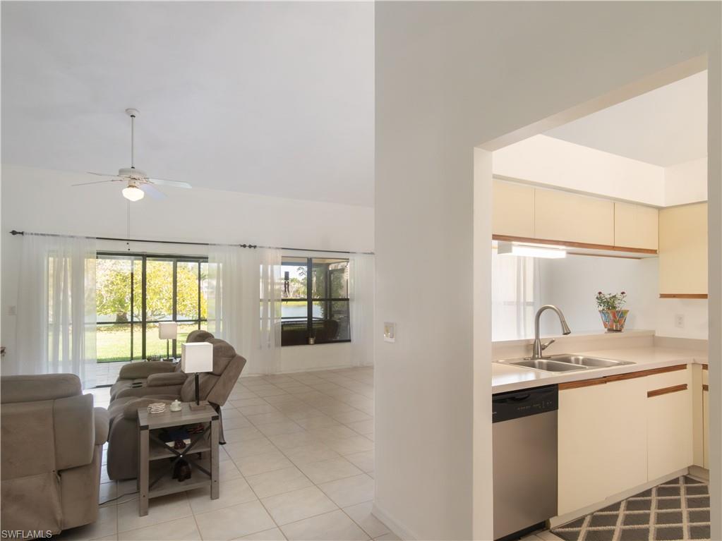 1404 Monarch Circle Naples, FL 34116 - Photo 10 of 33 a en suite bathroom with a granite countertop sink a mirror and a bathtub