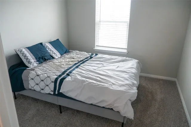 a bedroom with a bed and window