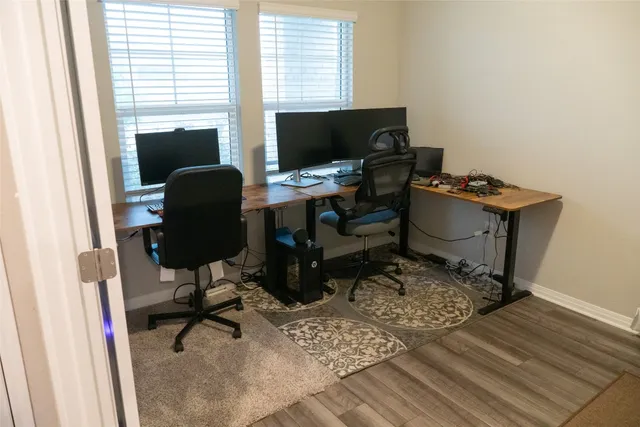 a view of a workspace with furniture and a window
