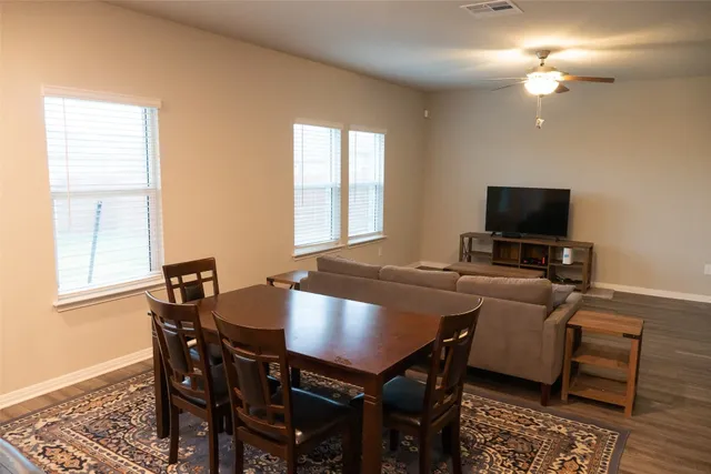 a view of a dining room with furniture and a flat screen tv