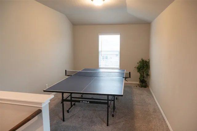a view of a room with a table and chairs in it
