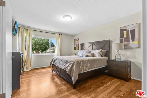 a spacious bedroom with a large bed and a window