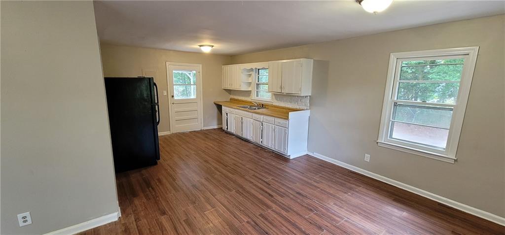 4267 Chamblee Tucker Road Atlanta, GA 30340 - Photo 6 of 12 a kitchen with granite countertop a refrigerator a sink and wooden floor
