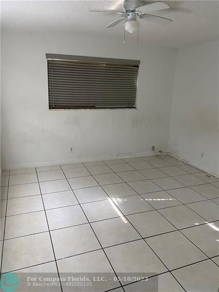 8020 Fairview Drive, Unit 101 Tamarac, FL 33321 - Photo 3 of 15 a view of a room with an empty space and a flat screen tv