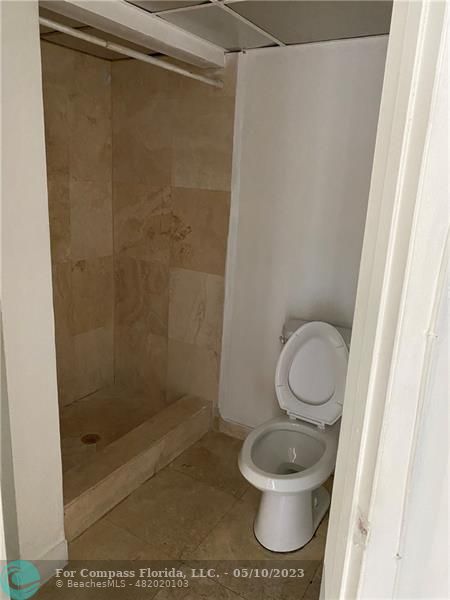 8020 Fairview Drive, Unit 101 Tamarac, FL 33321 - Photo 10 of 15 a white toilet sitting next to a shower