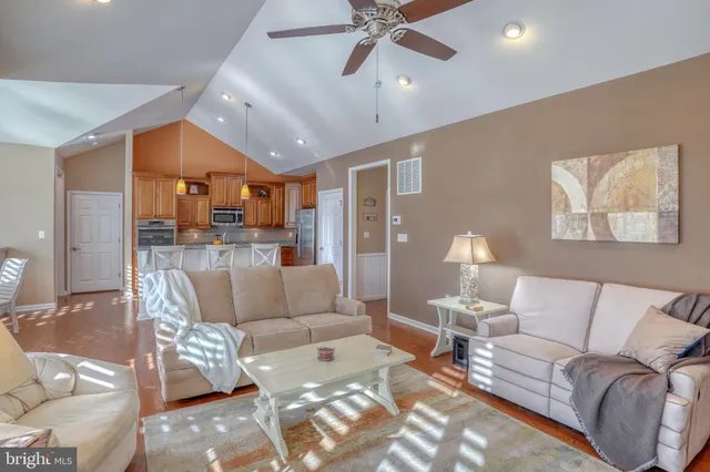 a kitchen with stainless steel appliances granite countertop a stove a sink a dining table and chairs