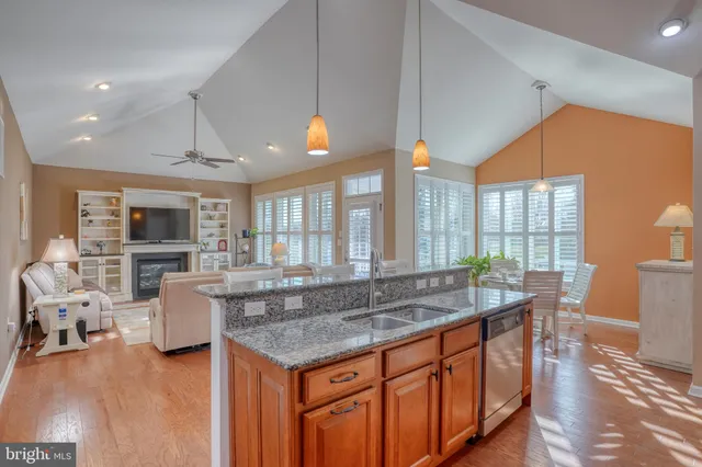 a kitchen with granite countertop a stove a sink and a granite counter tops