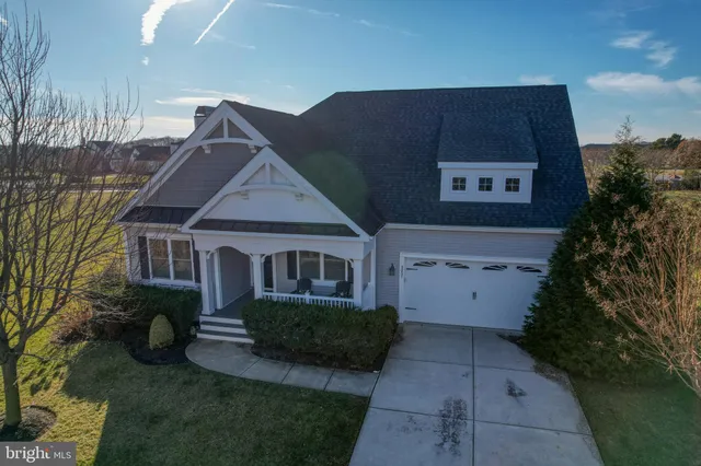 an aerial view of a residential houses with outdoor space and street view