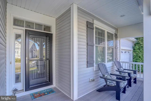 a view of a door with a chairs and table in a patio