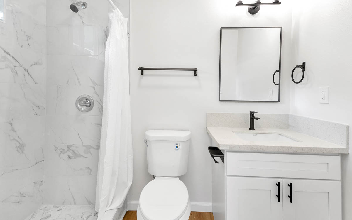 15-385 Puni Makai Loop North Pahoa, HI 96778 - Photo 15 of 22 a bathroom with a toilet sink vanity and mirror