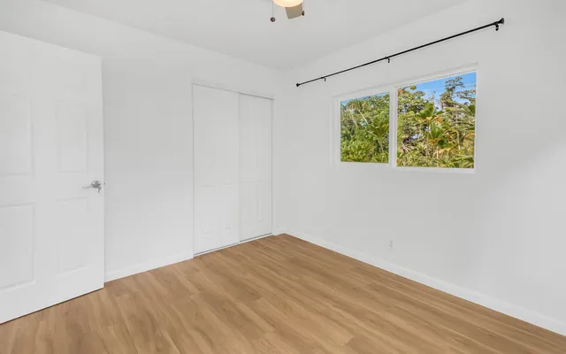 a view of room with window and hardwood floor