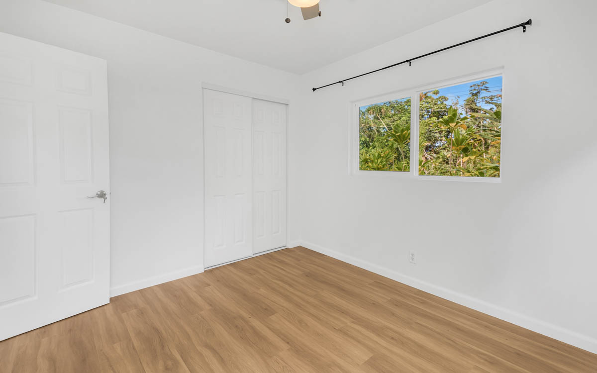 15-385 Puni Makai Loop North Pahoa, HI 96778 - Photo 19 of 22 a view of room with window and hardwood floor