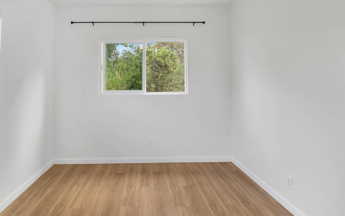 15-385 Puni Makai Loop North Pahoa, HI 96778 - Photo 20 of 22 a view of an empty room with wooden floor and a window