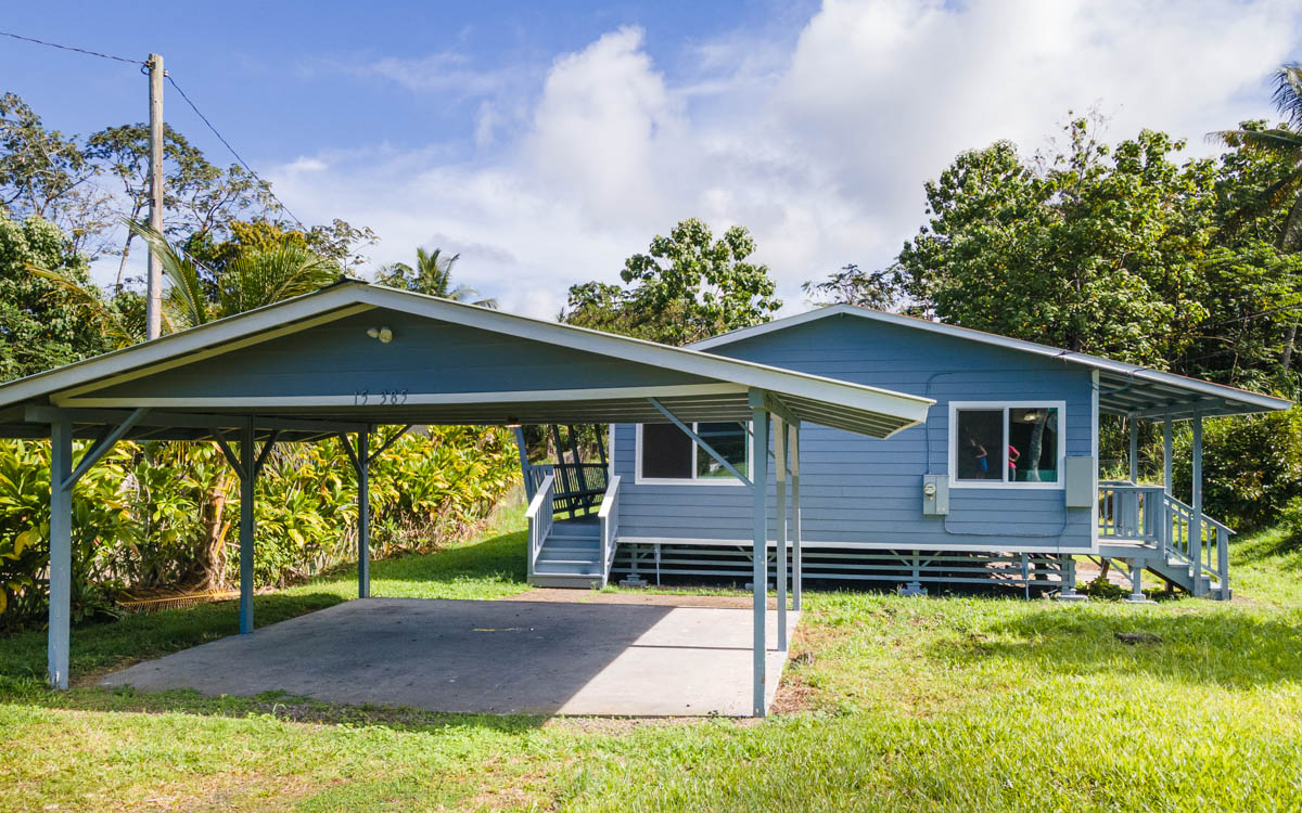 15-385 Puni Makai Loop North Pahoa, HI 96778 - Photo 5 of 22 a front view of a house with a yard
