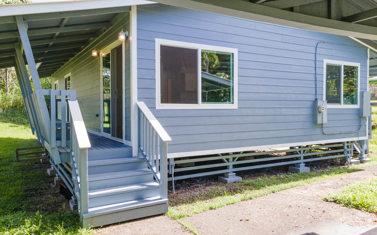 15-385 Puni Makai Loop North Pahoa, HI 96778 - Photo 6 of 22 a backyard of a house with wooden floor and outdoor seating
