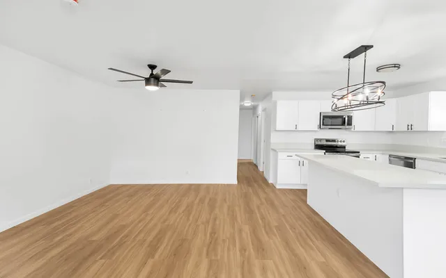 a view of kitchen with sink microwave and stove