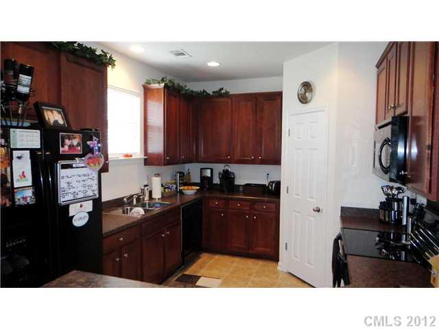 3343 Streamside Drive Davidson, NC 28036 - Photo 3 of 16 a kitchen with a refrigerator and a stove