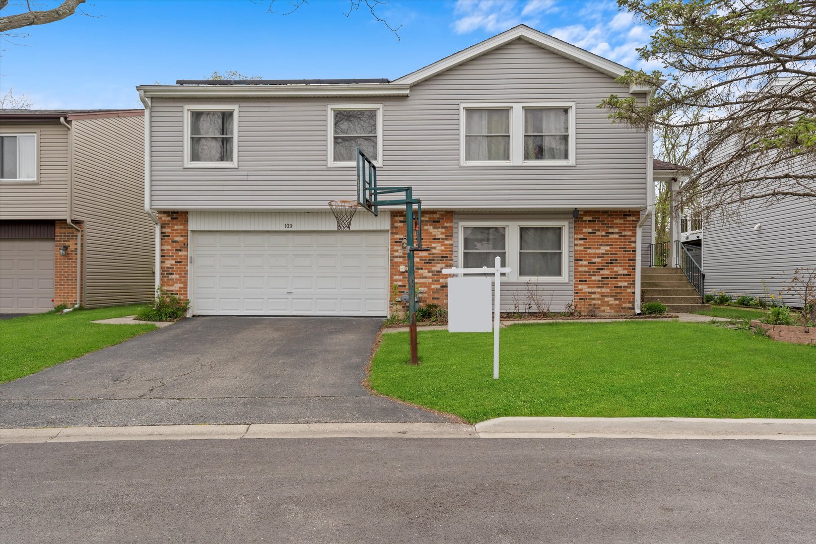 a front view of a house with a yard and garage