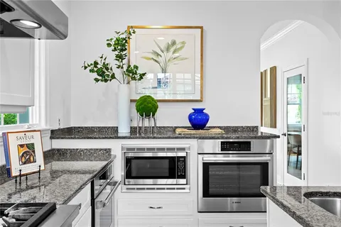 a kitchen with stainless steel appliances granite countertop a stove and a refrigerator