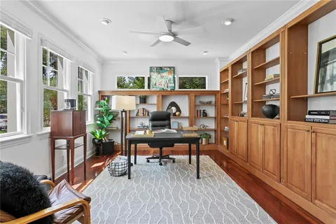 a workspace with furniture window and wooden floor