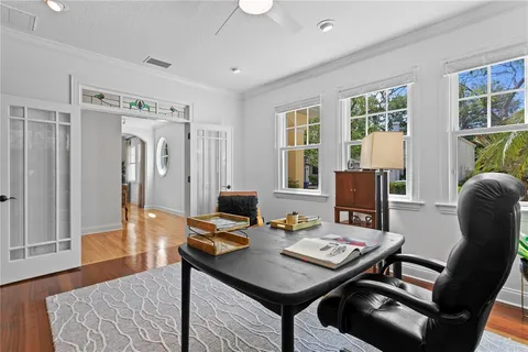 a view of a workspace with furniture and a table in a room