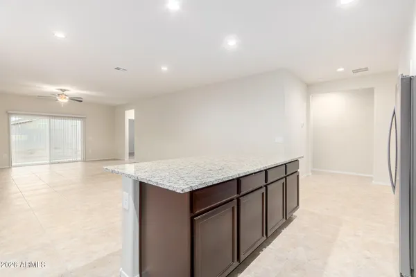 a kitchen with stainless steel appliances granite countertop a sink and a refrigerator