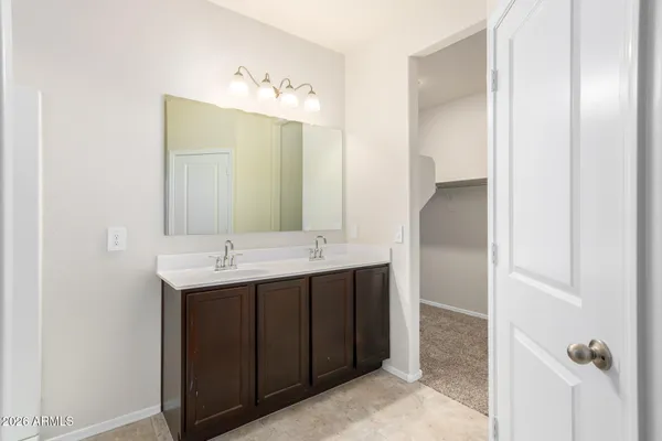 a bathroom with a double vanity sink and mirror