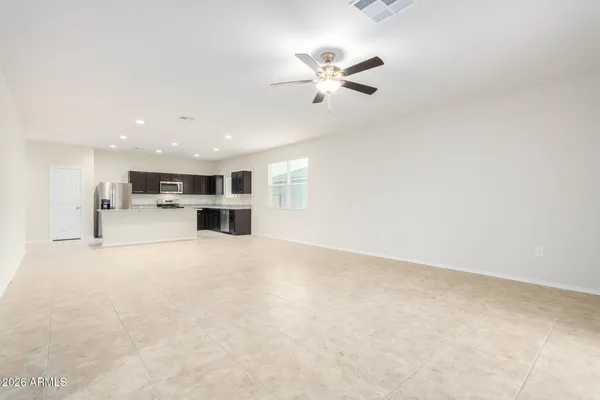 a view of a livingroom with furniture and a kitchen