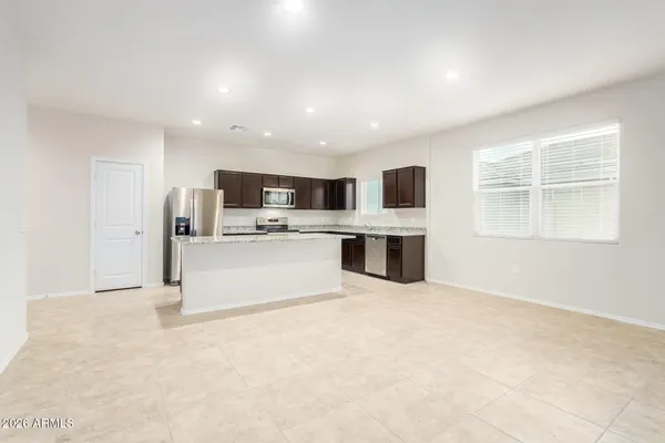 a view of kitchen with microwave oven stove and cabinets