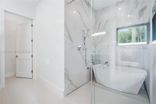 a bathroom with a bathtub and a shower