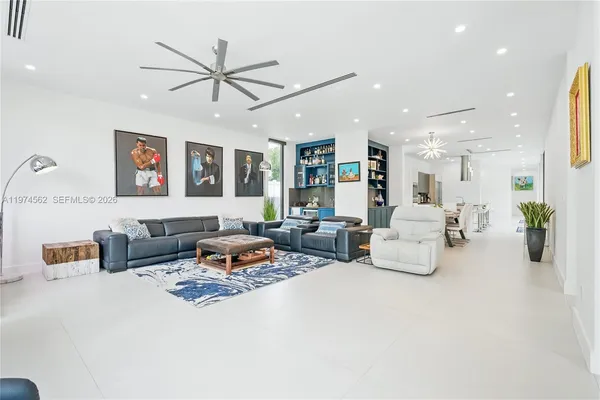 a living room with furniture and ceiling fan