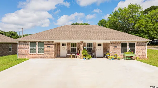 a view of a house with sitting area and garden