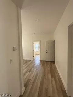a view of a room with wooden floor and window