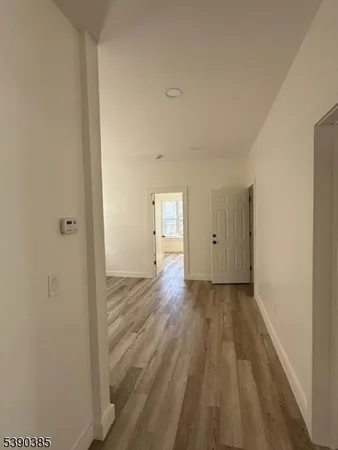 a view of a room with wooden floor and window