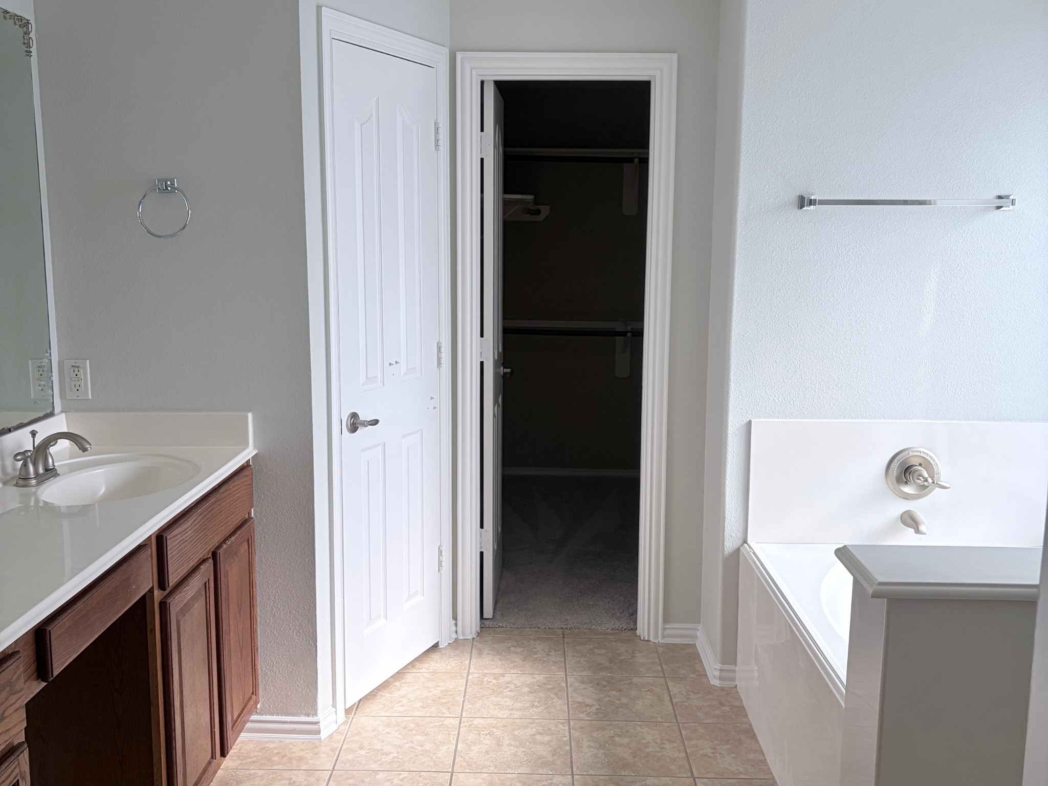 19723 Imperial Colony Lane Katy, TX 77449 - Photo 13 of 16 Primary bathroom vanity area with dual sinks, wooden cabinetry, and adjacent walk-in closet.