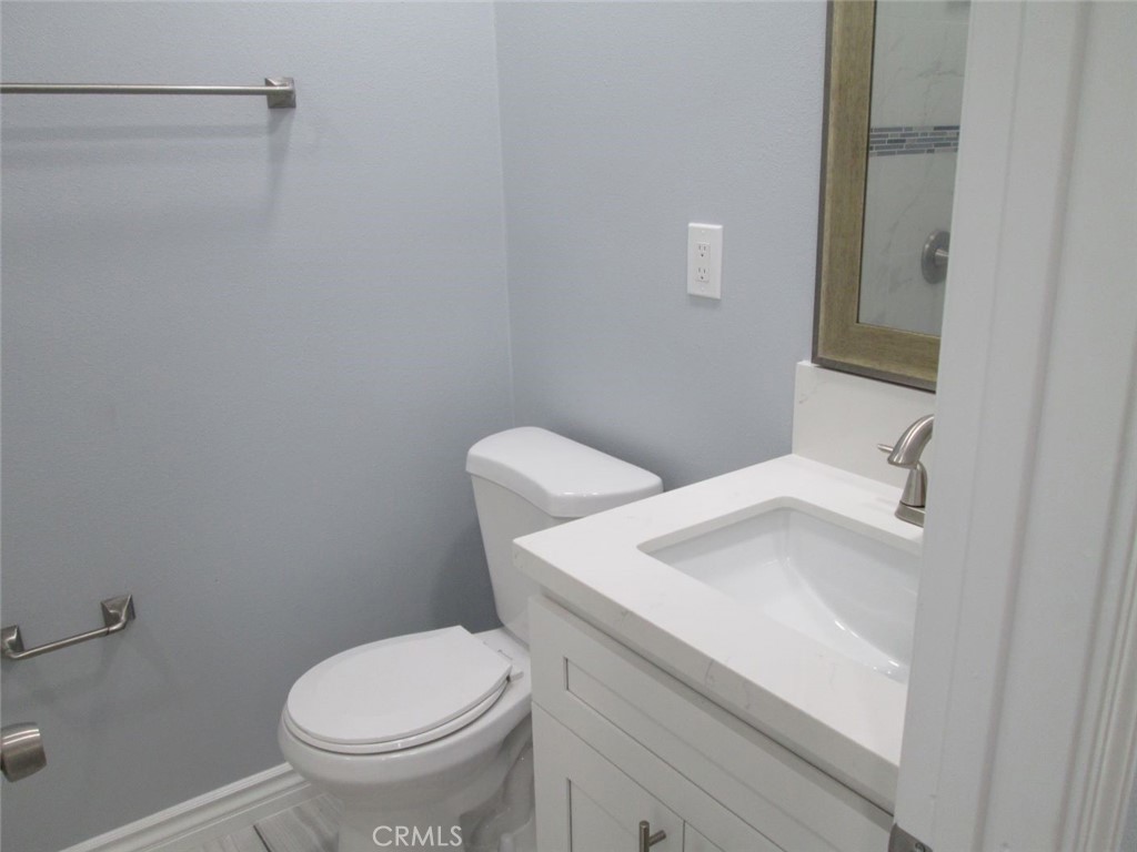 44552 Arabia Street Indio, CA 92201 - Photo 11 of 49 a white toilet sitting next to a bathroom sink