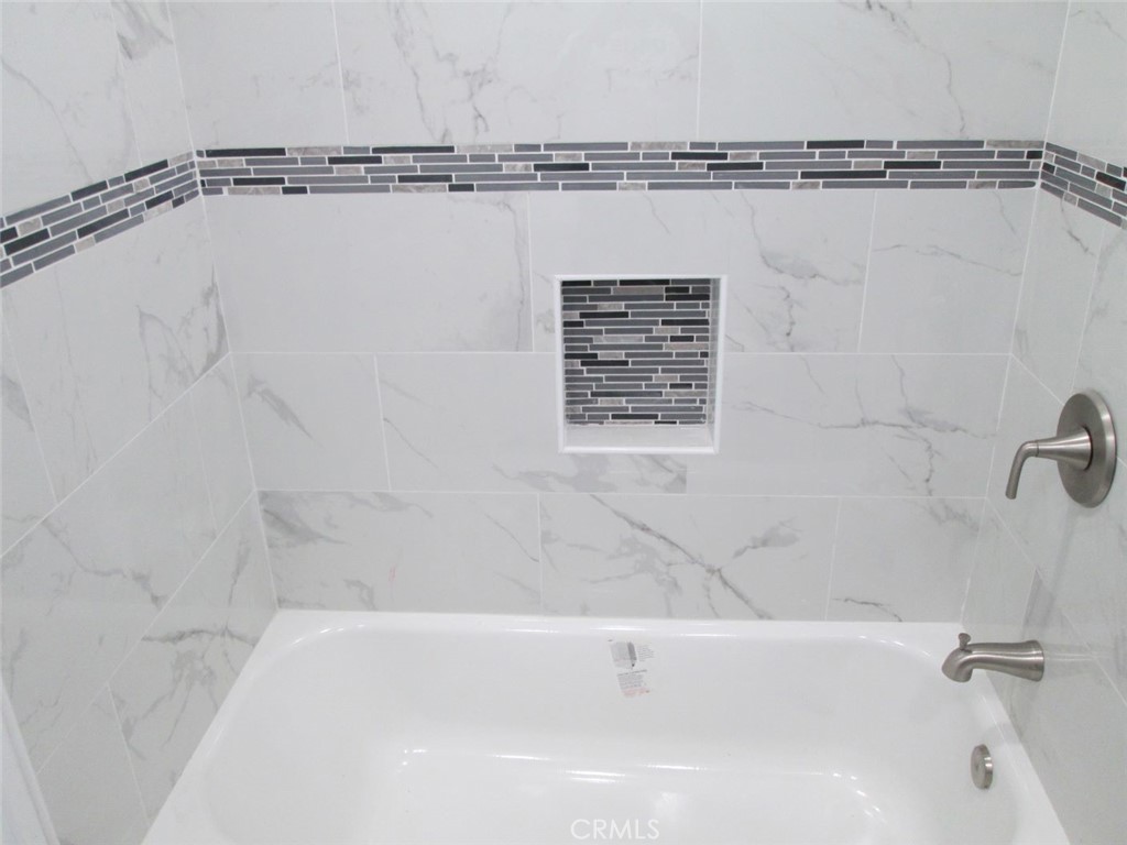 44552 Arabia Street Indio, CA 92201 - Photo 14 of 49 a bathroom with a shower and a bath tub