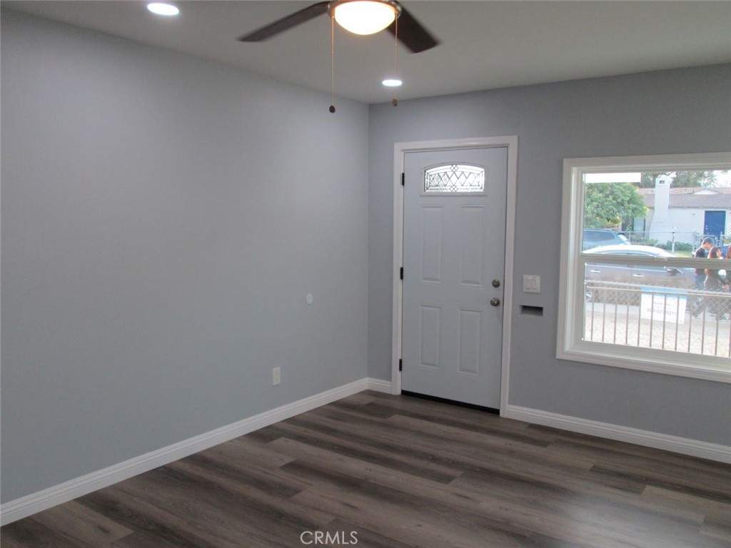44552 Arabia Street Indio, CA 92201 - Photo 16 of 49 an empty room with wooden floor and windows