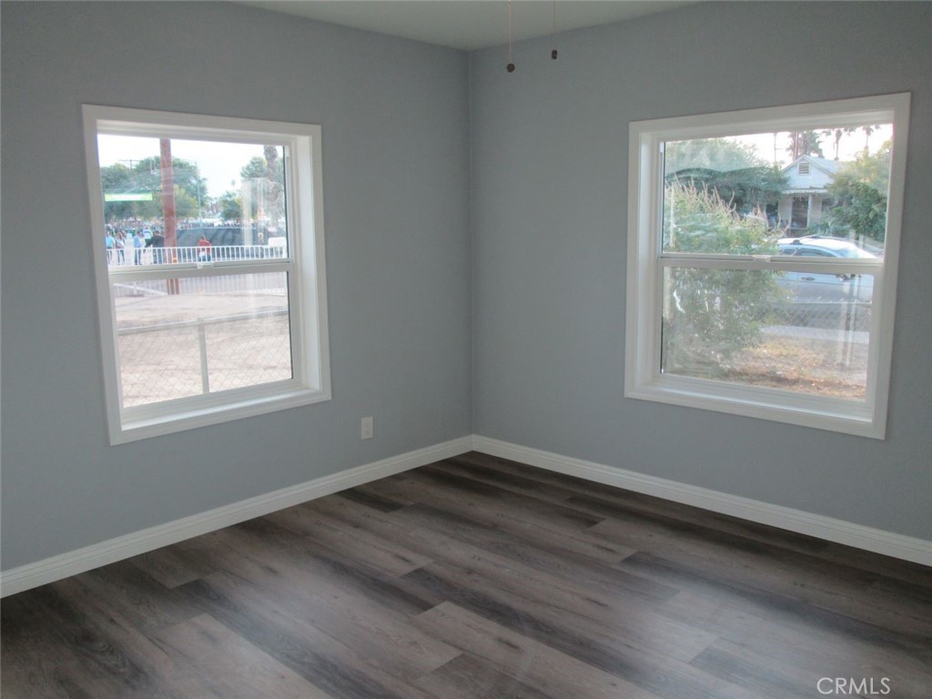 44552 Arabia Street Indio, CA 92201 - Photo 17 of 49 an empty room with wooden floor and windows