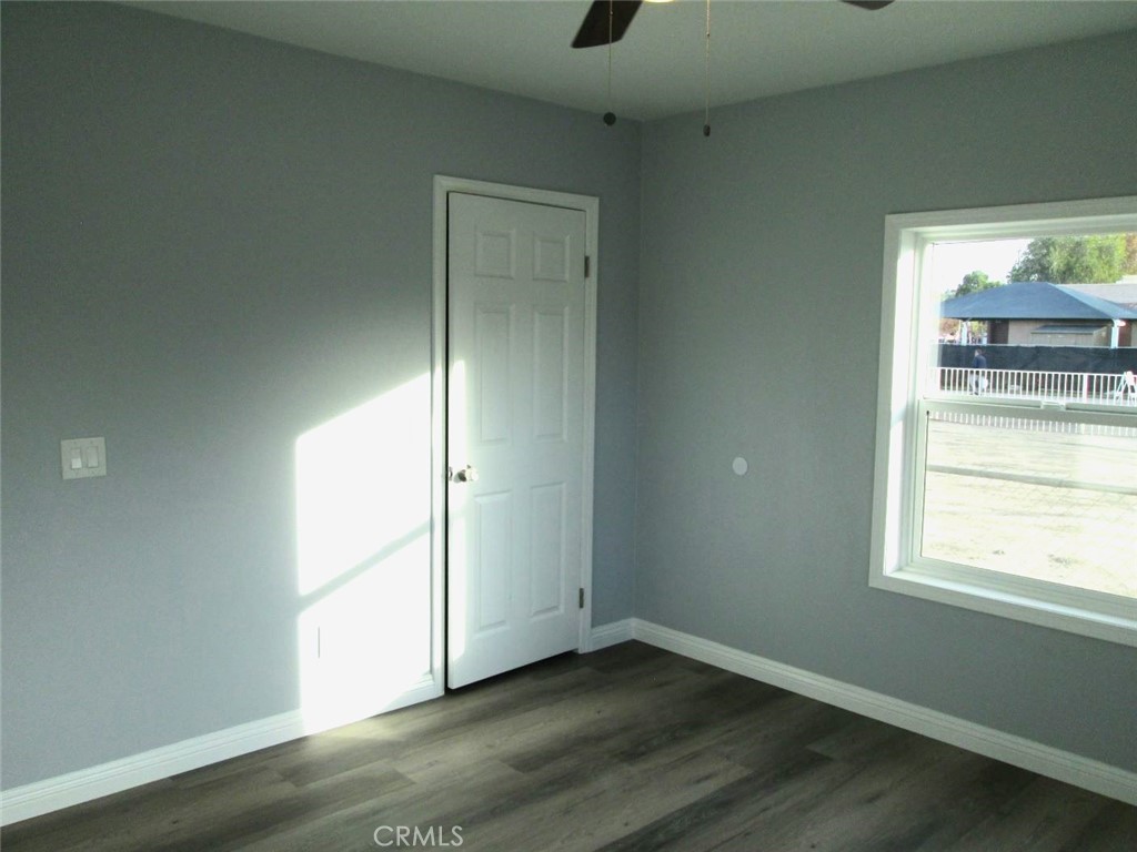 44552 Arabia Street Indio, CA 92201 - Photo 18 of 49 an empty room with wooden floor and windows