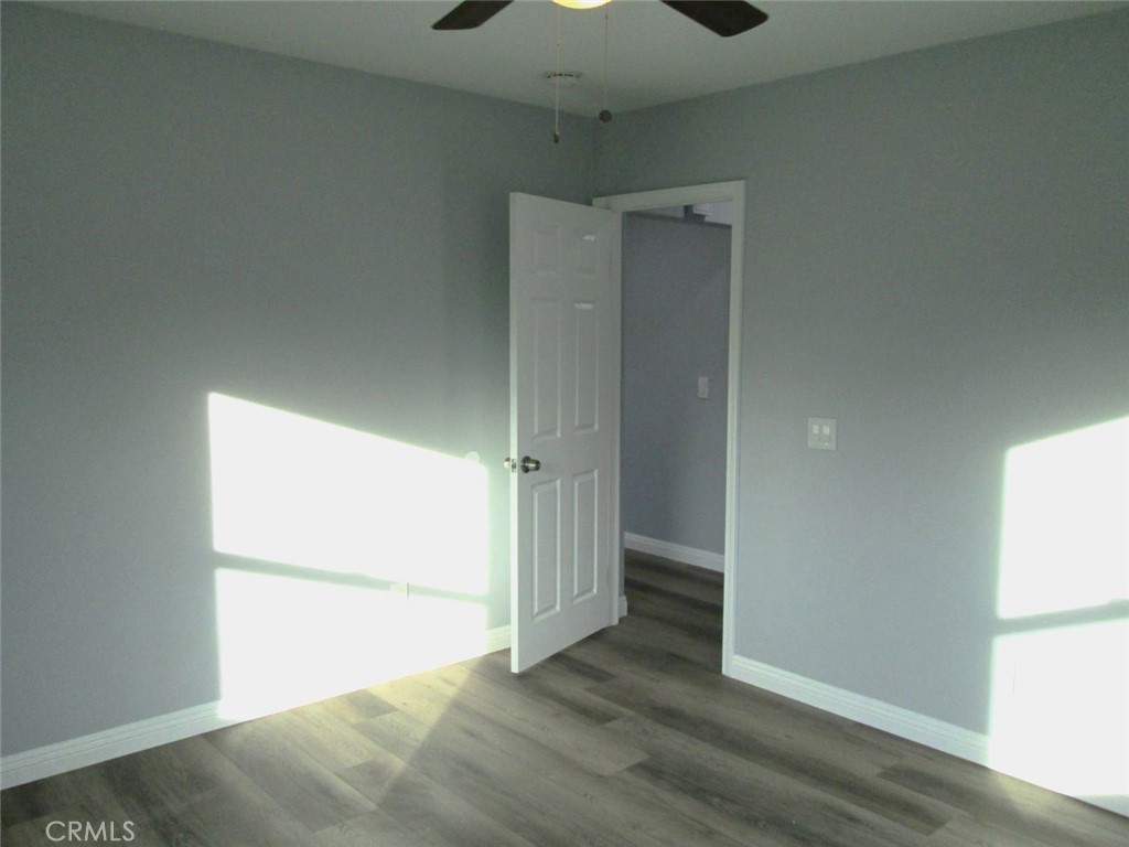 44552 Arabia Street Indio, CA 92201 - Photo 19 of 49 an empty room with wooden floor cabinet and windows