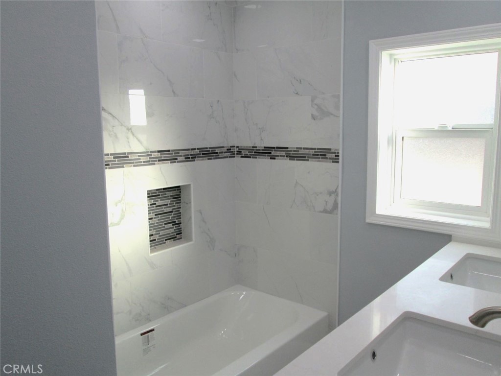 44552 Arabia Street Indio, CA 92201 - Photo 20 of 49 a bathroom with a bathtub and a shower