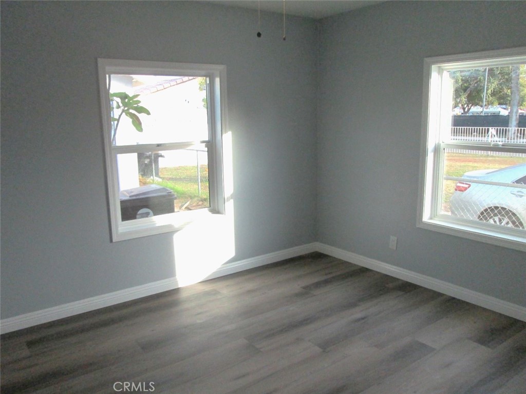 44552 Arabia Street Indio, CA 92201 - Photo 23 of 49 an empty room with wooden floor and windows