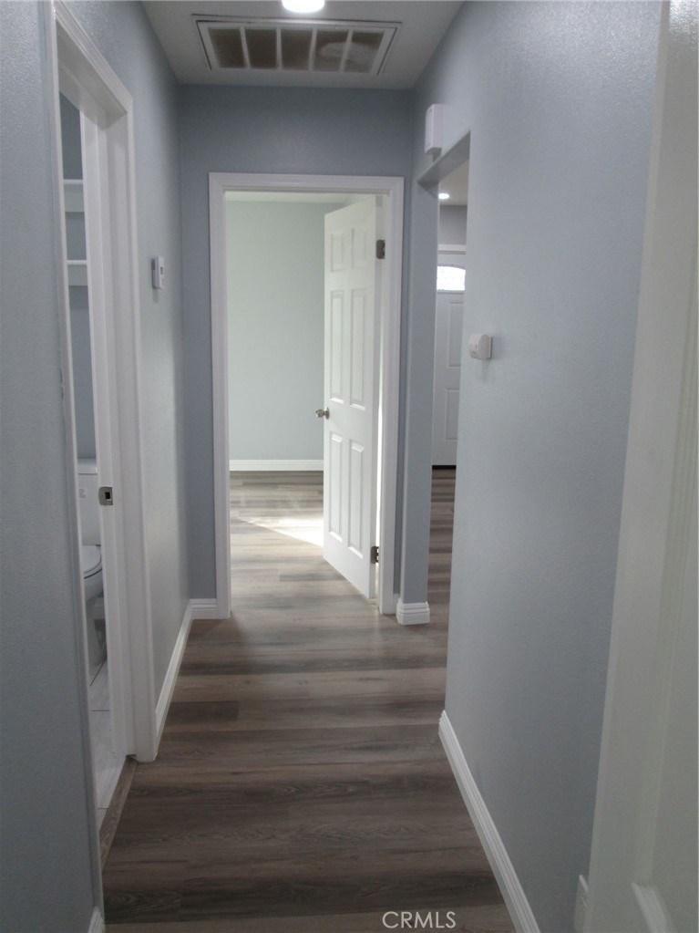 44552 Arabia Street Indio, CA 92201 - Photo 27 of 49 a view of a hallway with wooden floor and entryway
