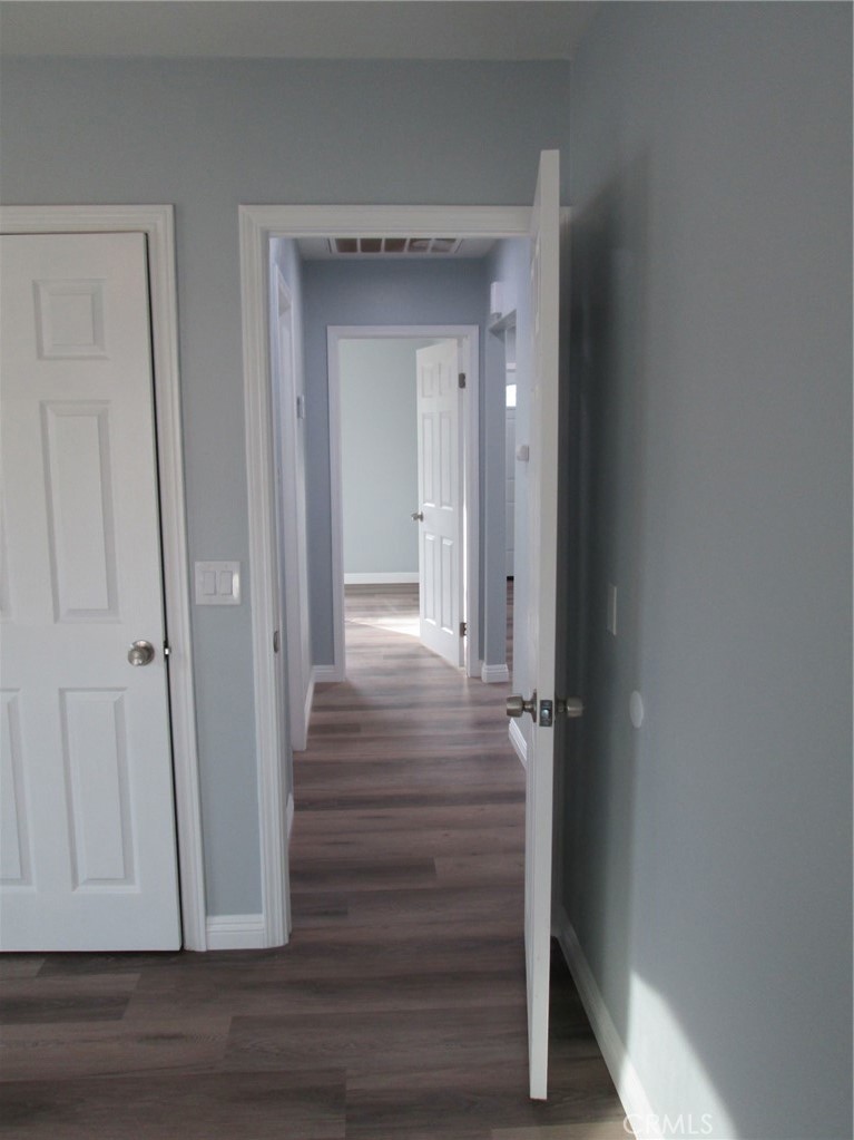 44552 Arabia Street Indio, CA 92201 - Photo 28 of 49 a view of a hallway with wooden floor and closet