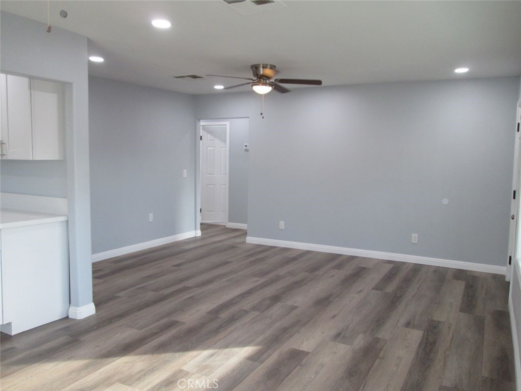 44552 Arabia Street Indio, CA 92201 - Photo 3 of 49 an empty room with wooden floor and windows