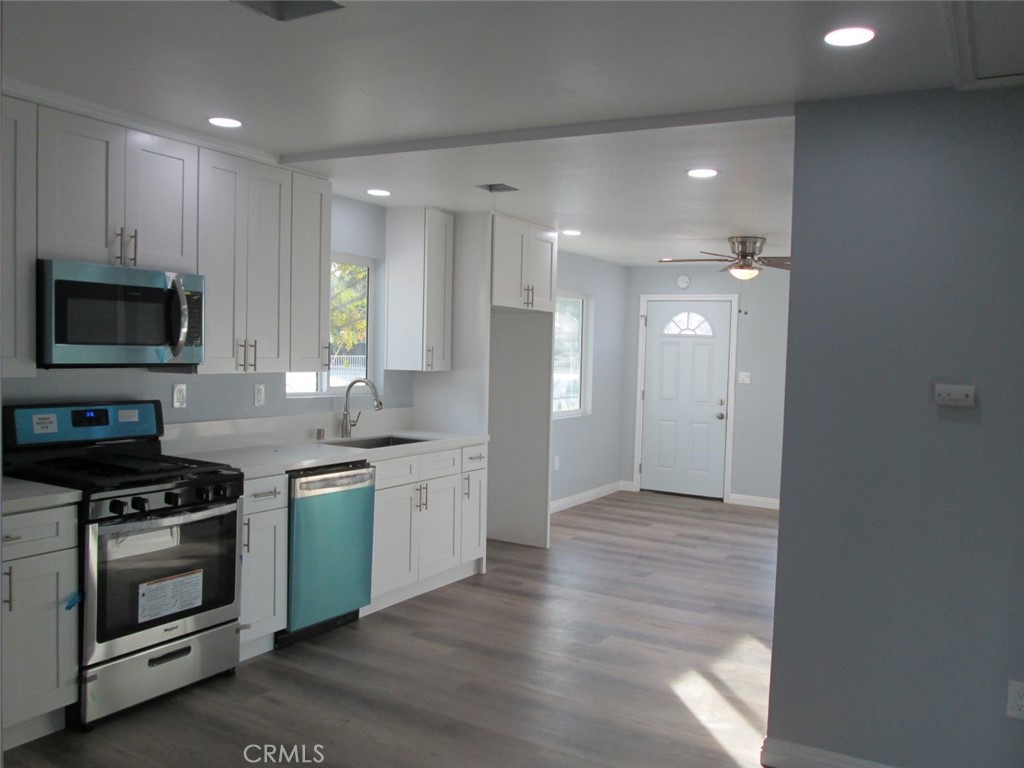 44552 Arabia Street Indio, CA 92201 - Photo 34 of 49 a kitchen with stainless steel appliances granite countertop a stove a sink and a refrigerator