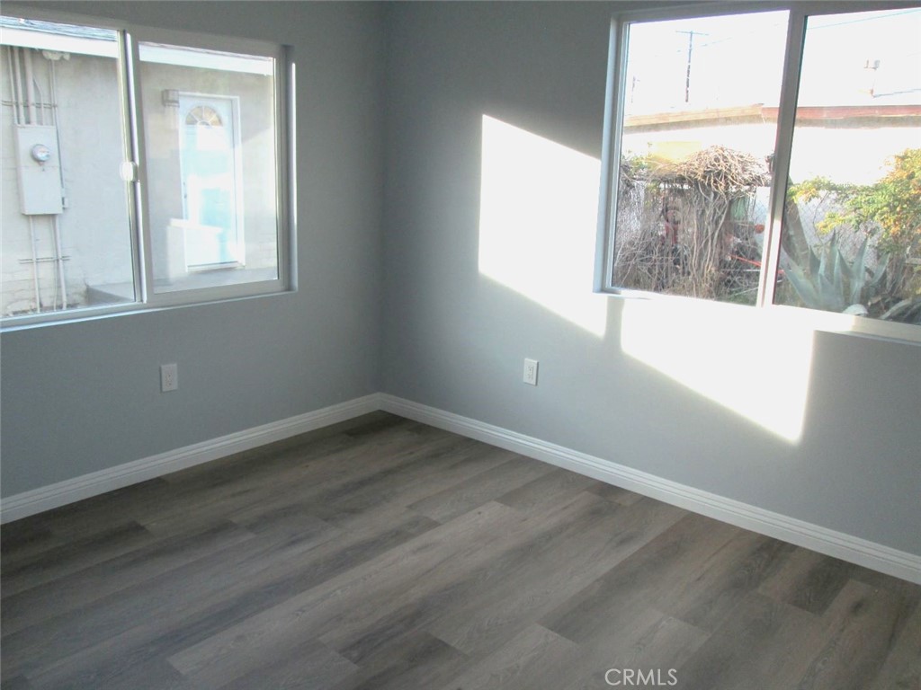 44552 Arabia Street Indio, CA 92201 - Photo 38 of 49 a view of empty room with wooden floor and fan