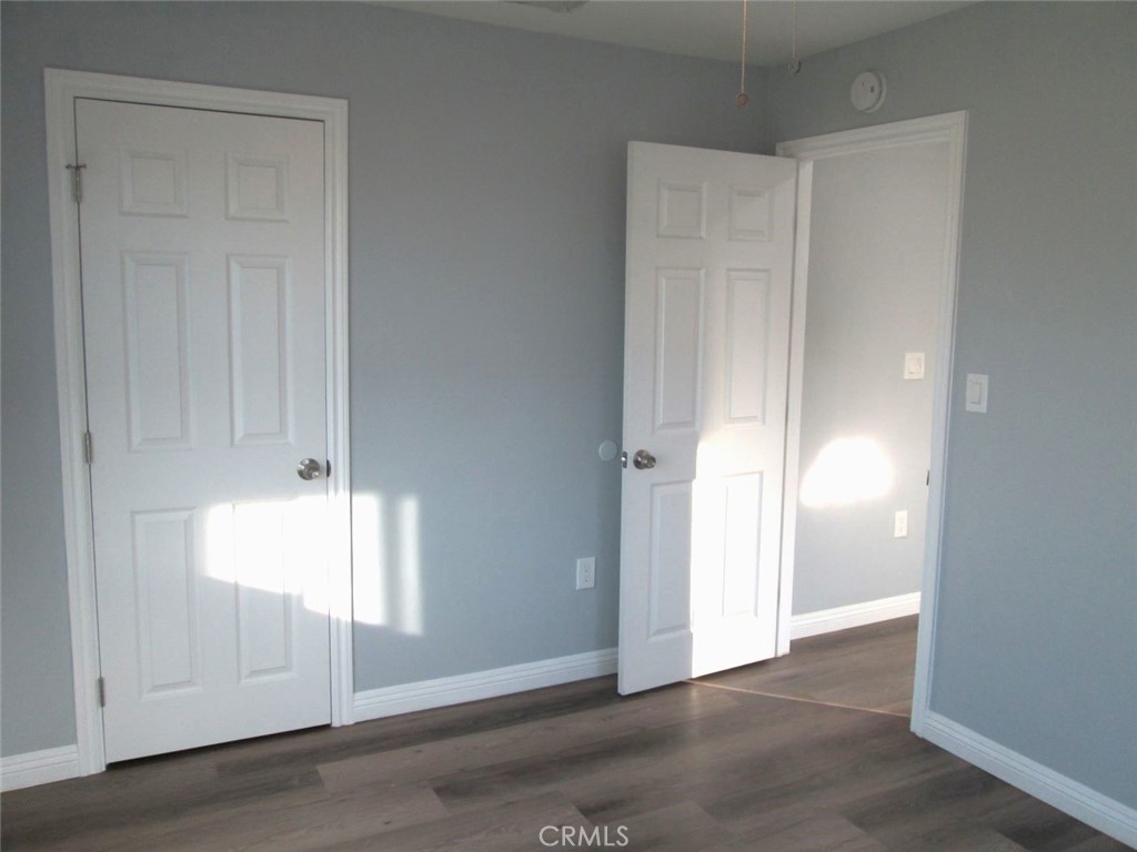 44552 Arabia Street Indio, CA 92201 - Photo 39 of 49 an empty room with wooden floor and windows