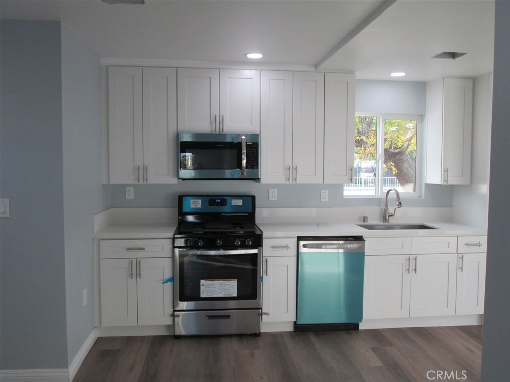 44552 Arabia Street Indio, CA 92201 - Photo 42 of 49 a kitchen with sink a microwave and cabinets